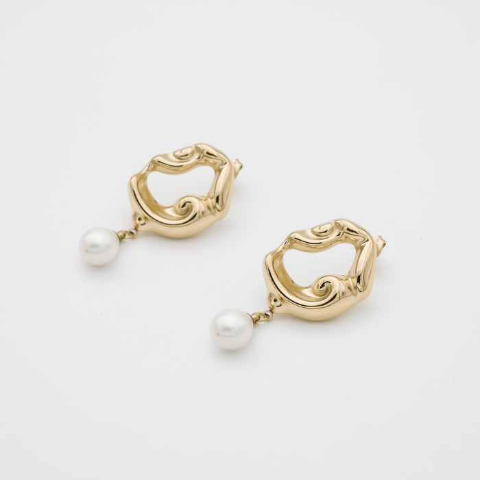 Gold earrings with pearl drops, abstract design.