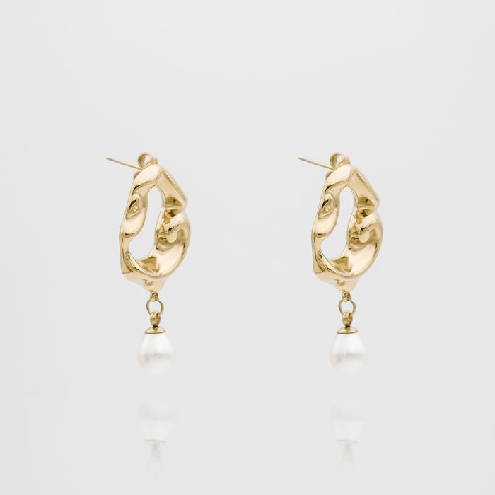 Gold earrings with pearl drops, abstract design.