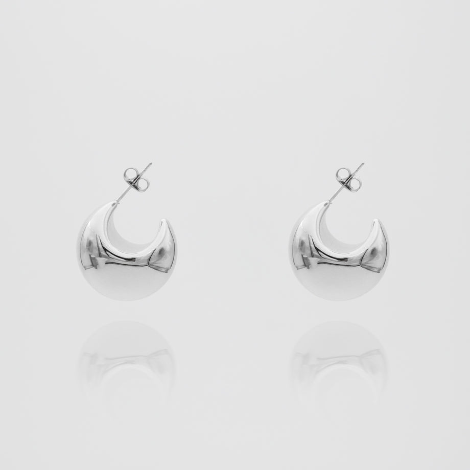 silver half hoop Imani Earrings on white background.