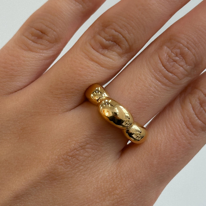 model wearing Lia Bubble Band Ring, crescent-shaped bubble design crafted in 18k gold plated stainless steel from prya