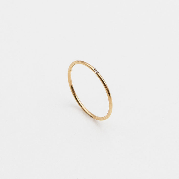 Gold ring with a small diamond.