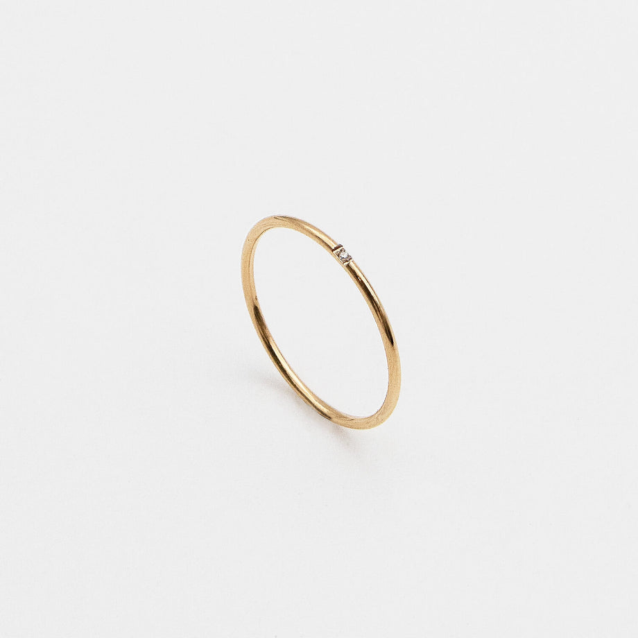 Gold ring with a small diamond.