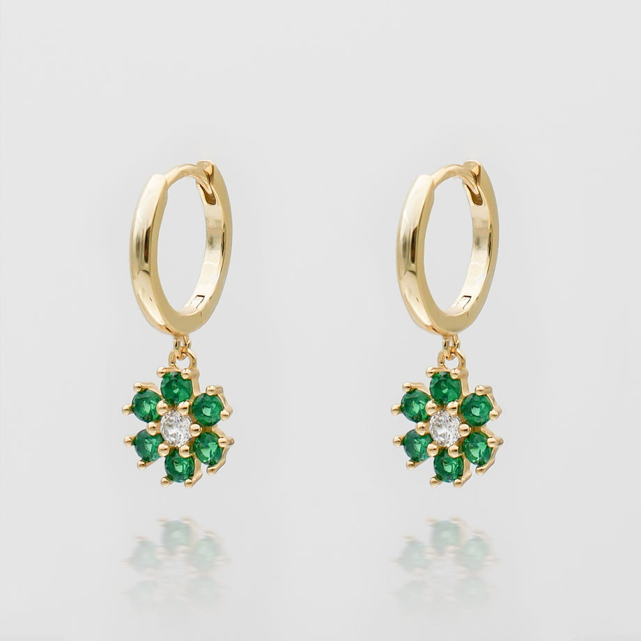 Gold hoop earrings with green flower charms.