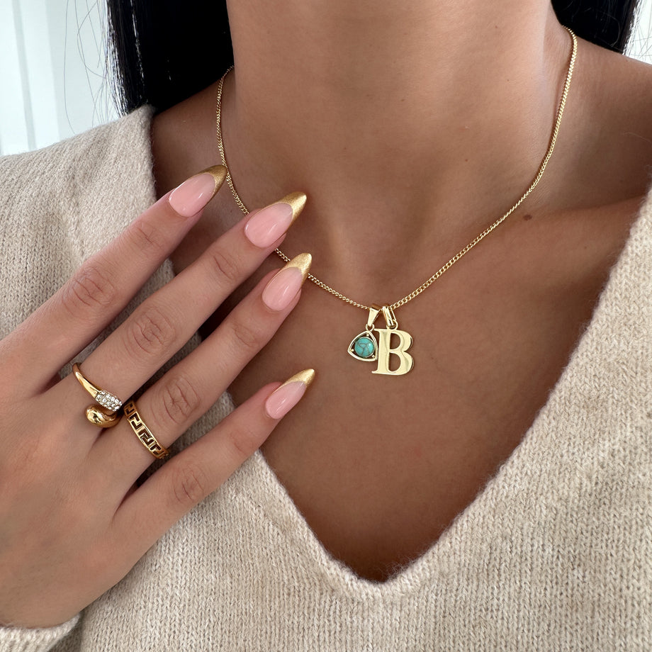 Model wearing Gold initial birthstone necklace