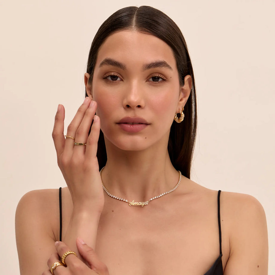 model wearing Miami name tennis necklace in gold from prya