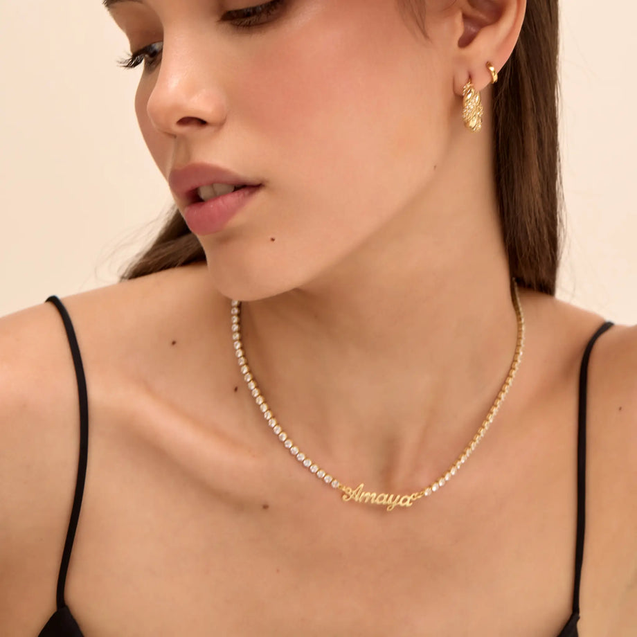 model wearing Miami name tennis necklace in gold from prya