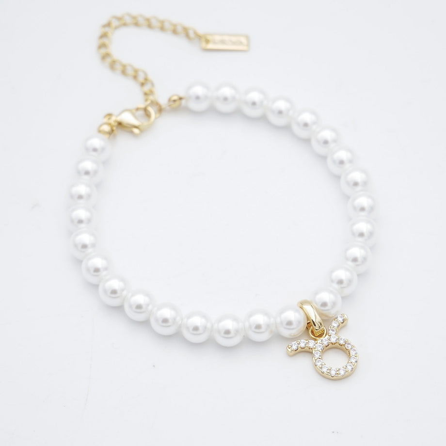 Gold charm pearl anklet with adjustable clasp.