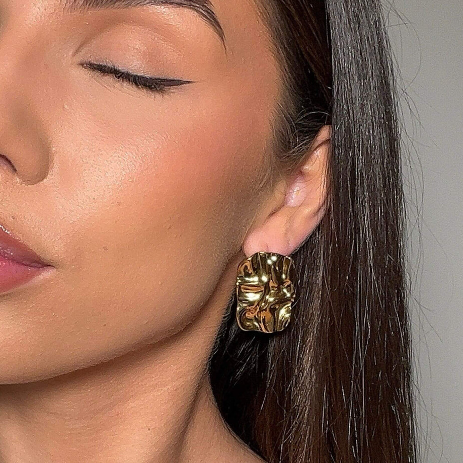 video of model wearing elena textured gold earrings