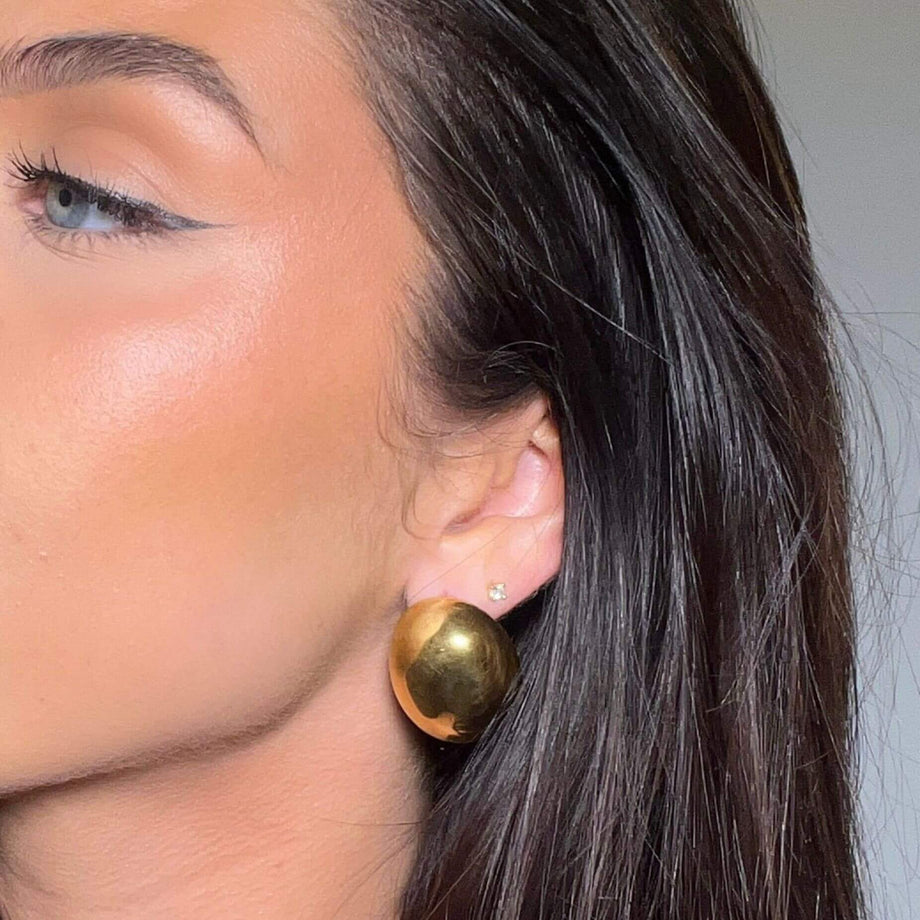 model wearing maeve earrings in gold from prya
