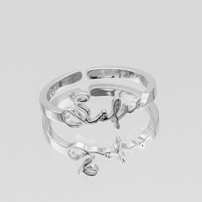 silver ring with custom name design.