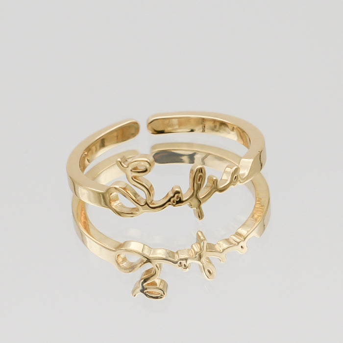 Gold ring with custom name design.