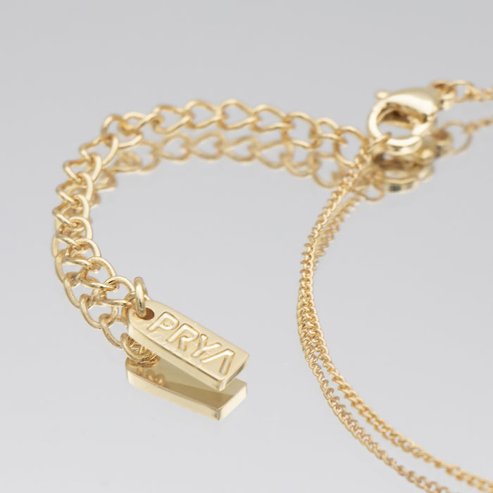 Maia mini initial bracelet in 18k gold with PRYA pendant on a delicate chain