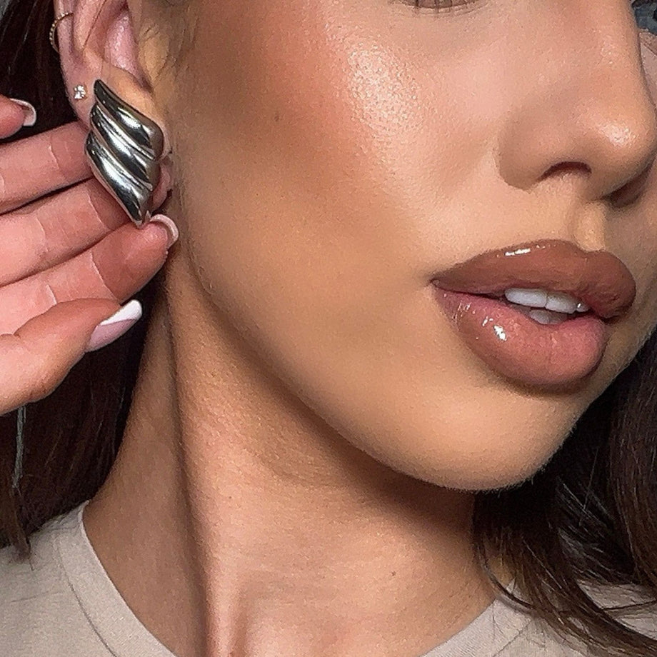 model wearing zaya statement earrings in silver from prya