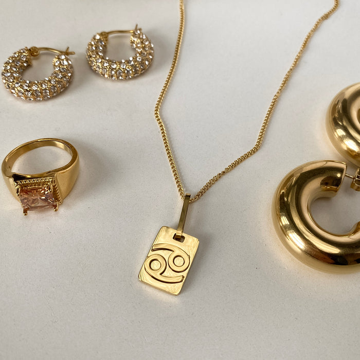 image of gold plated products, zodiac necklace, chunky hoops and gemstone rings from prya