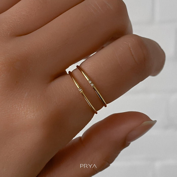 model wearing two gold ring with small cz stones