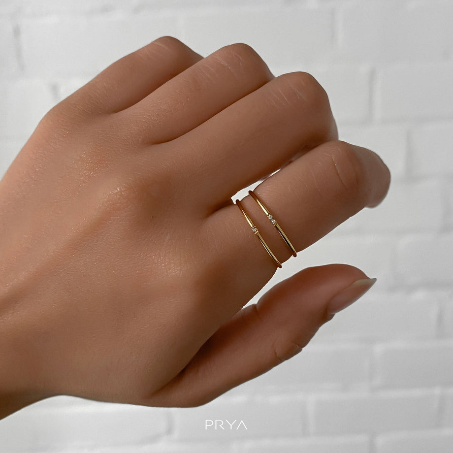 model wearing two gold ring with small cz stones
