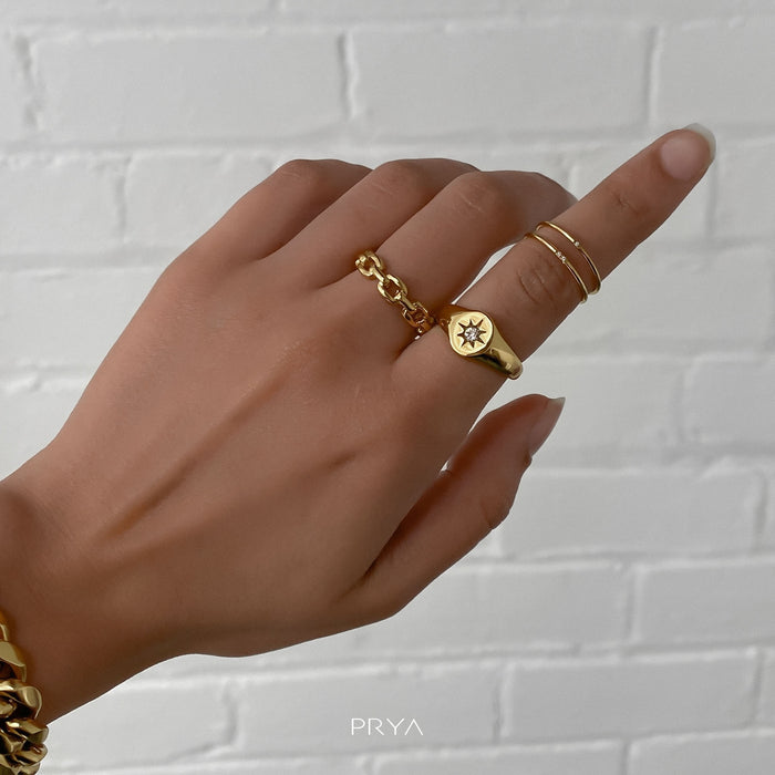 model wearing two gold ring with small cz stones