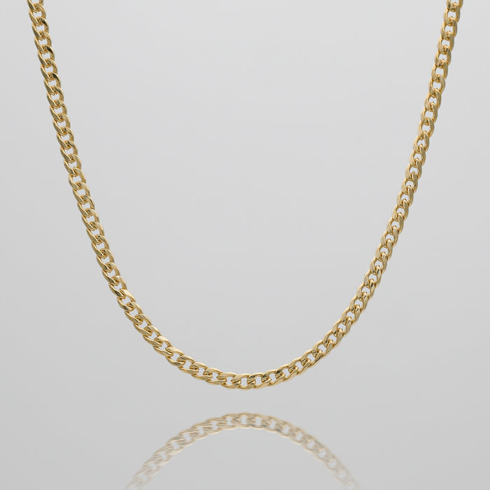 Gold Cuban pendant chain on white background.