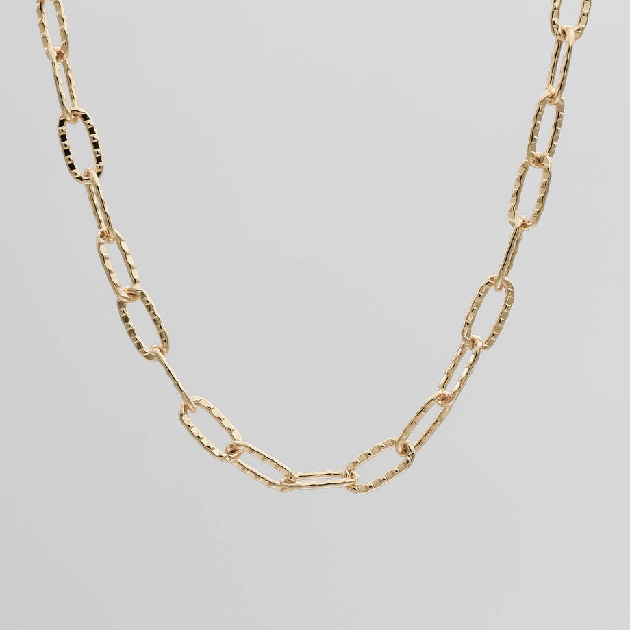 Gold chain necklace with textured links.
