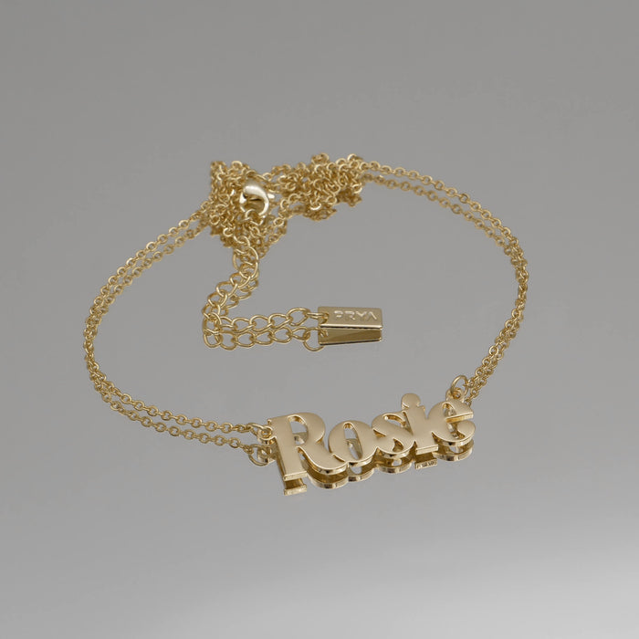 Gold "Rosie" name necklace on a chain.