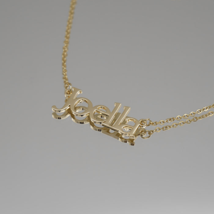 Gold necklace with "Joella" name pendant.