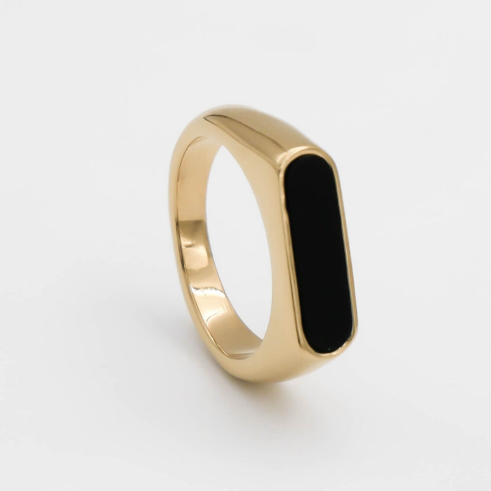 Gold ring with an oval black inlay.