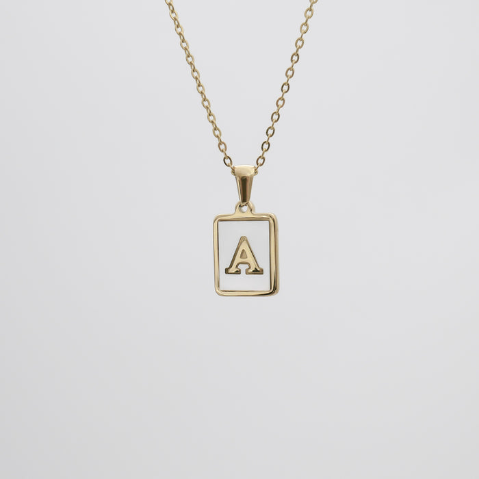 Gold opal necklace with a letter "A" pendant.
