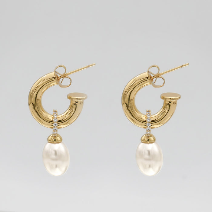 Gold hoop earrings with pearl drops.