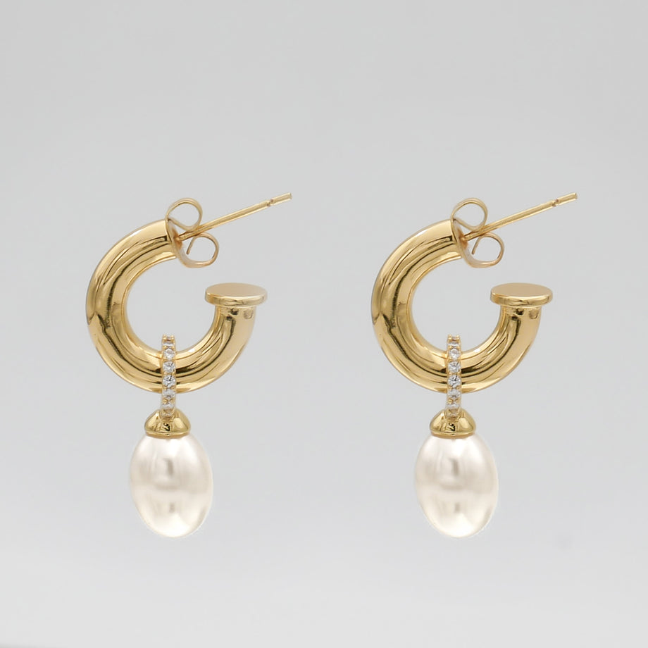 Gold hoop earrings with pearl drops.