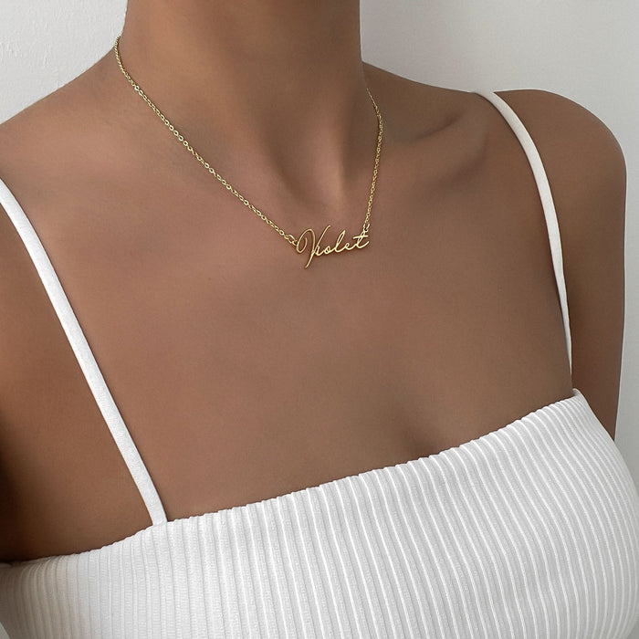 Model wearing Personalised signature name necklace in 18K gold classic link chain made by PRYA UK