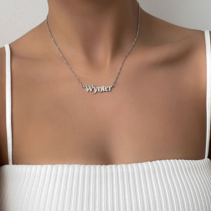 model wearing gold personalised name necklace from prya
