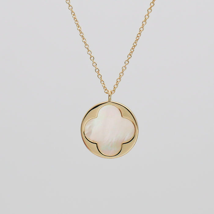 Gold necklace with clover-shaped pendant.