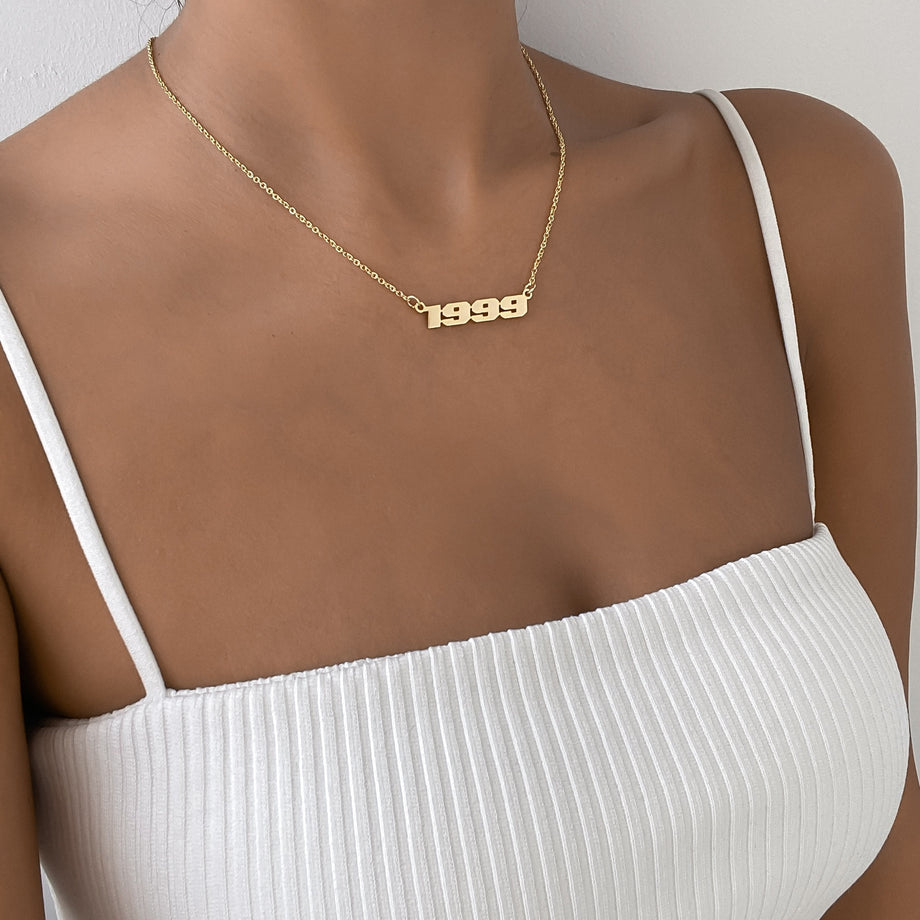 model wearing 18k gold plated birth year action necklace from prya