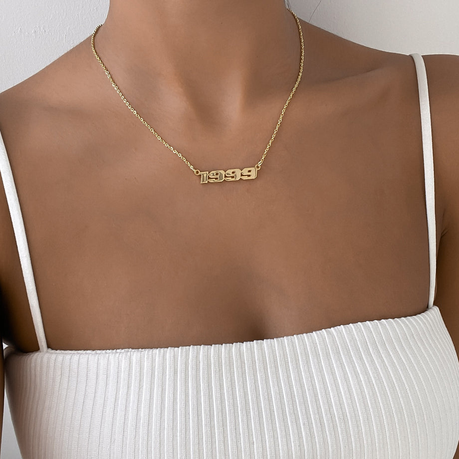 model wearing 18k gold plated birth year action necklace from prya