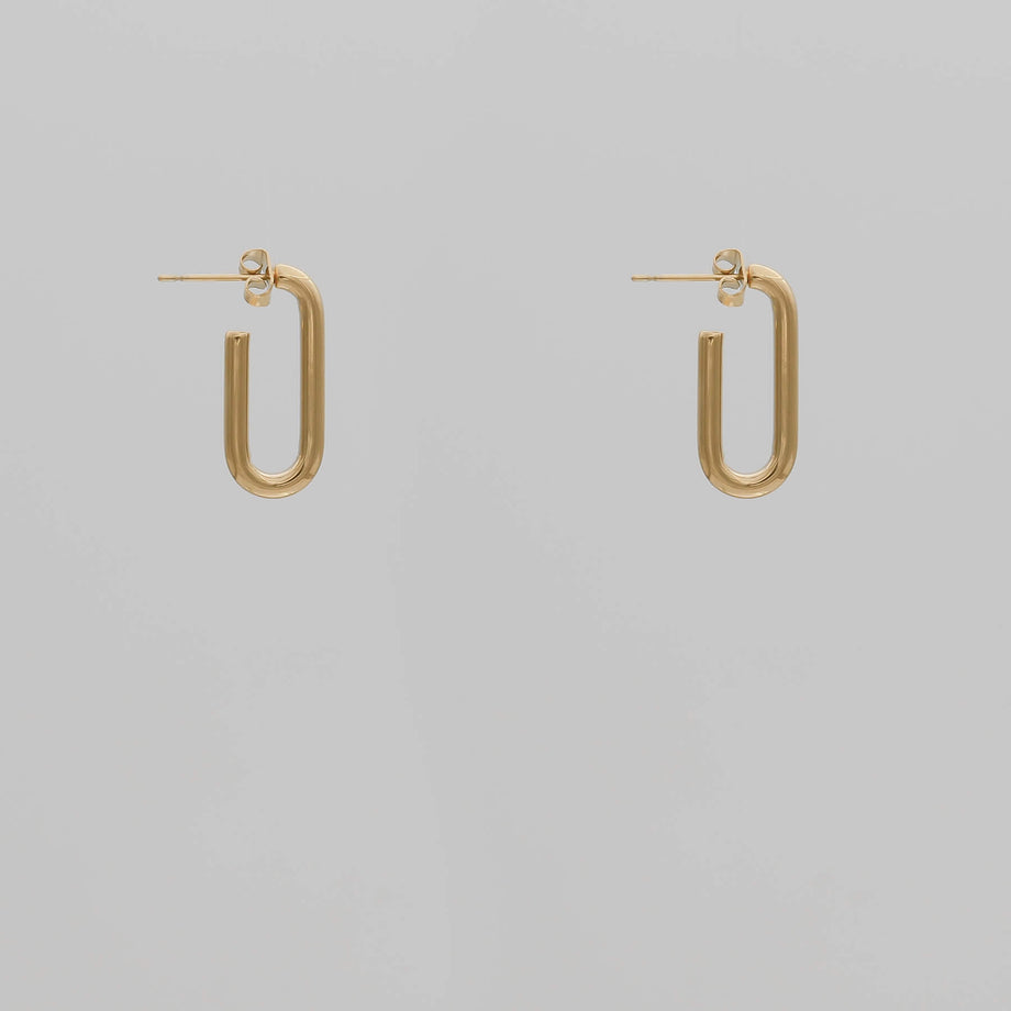 Gold chain adjustable link earrings with one link on grey background.