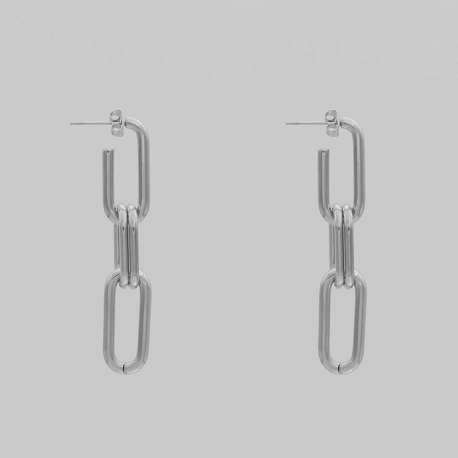 silver chain adjustable link earrings with three links on grey background.