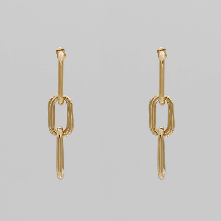 Gold chain adjustable link earrings with three links on grey background.