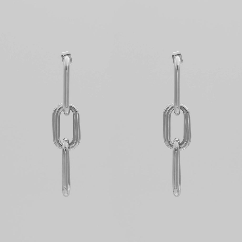 silver chain adjustable link earrings with three links on grey background.