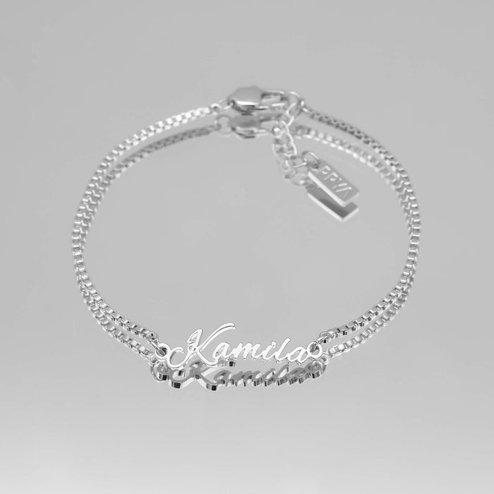 silver name bracelet with double chain.