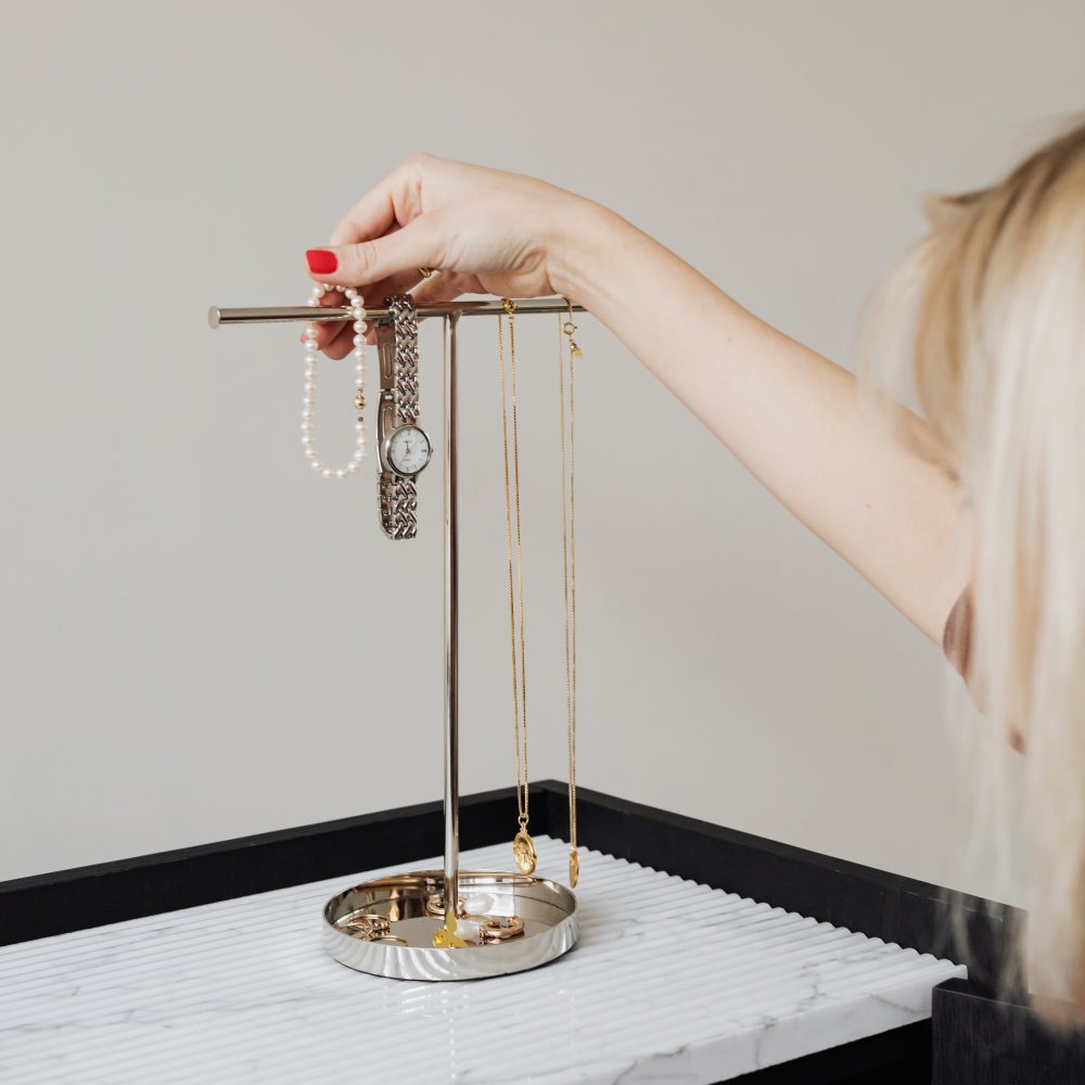 How to Clean Jewellery - Woman putting jewellery on stand