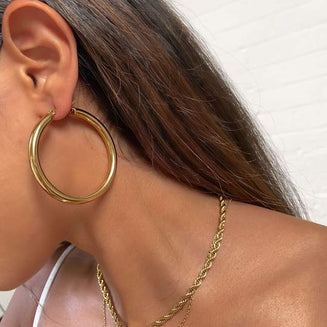 How To Put Hoop Earrings In - Women with large gold hoop earrings