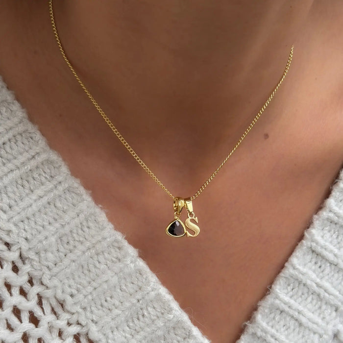 model wearing Kayla lower case initial and birthstone necklace with in gold