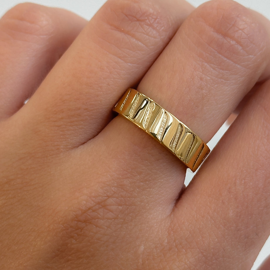 model wearing Amaia Band Ring, featuring striped engraving, crafted in 18k gold plated stainless steel