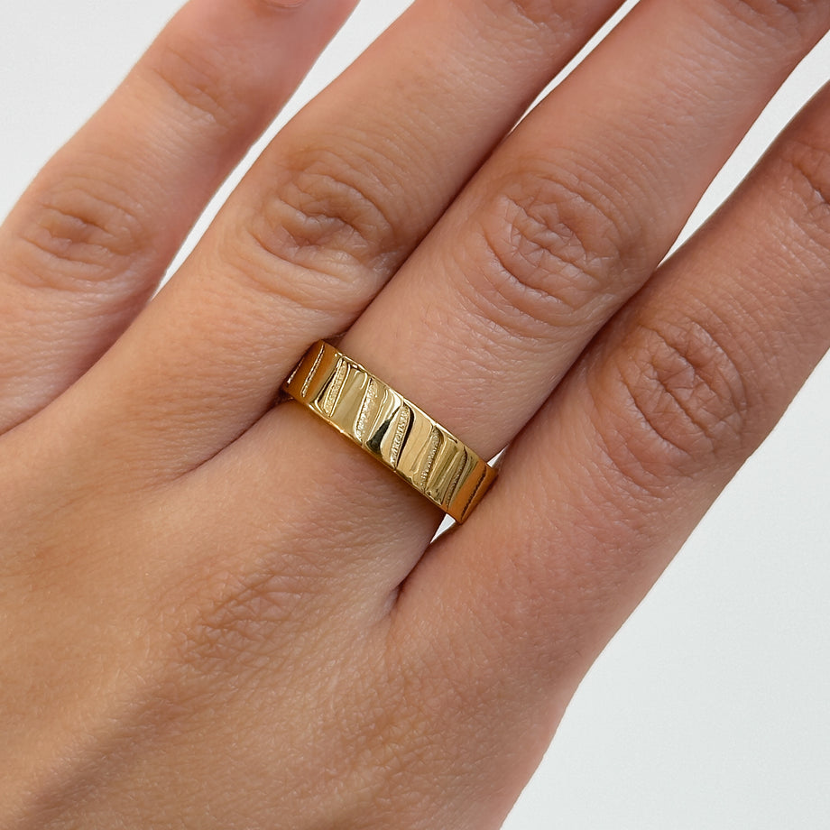 model wearing Amaia Band Ring, featuring striped engraving, crafted in 18k gold plated stainless steel