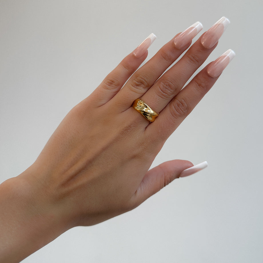 model wearing Amelie Band Ring, featuring smooth lines and polished finish, crafted in 18k Gold plated stainless steel from Prya