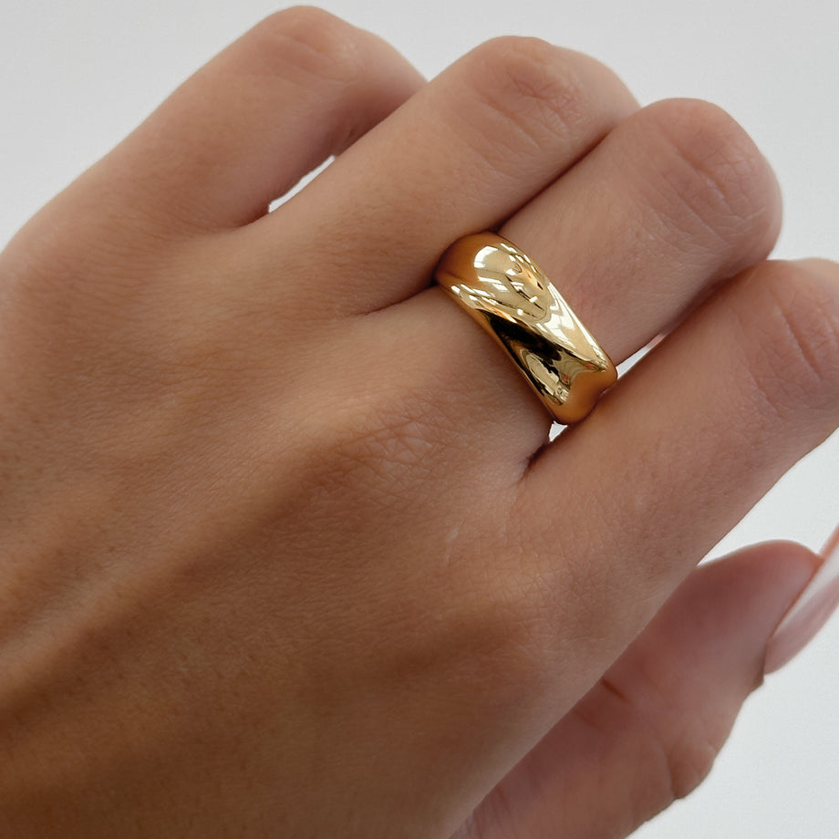 model wearing Amelie Band Ring, featuring smooth lines and polished finish, crafted in 18k Gold plated stainless steel from Prya