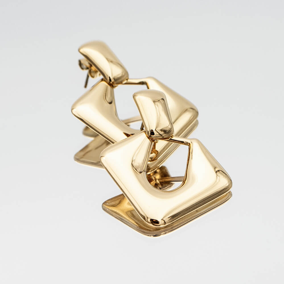 Anika Earrings are stunning Gold plated Drop earrings featuring a sleek, modern door knocker design from prya