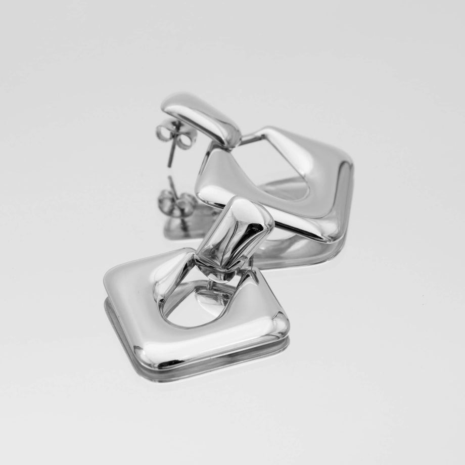 Anika Earrings are stunning silver plated Drop earrings featuring a sleek, modern door knocker design from prya