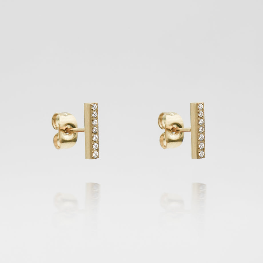 Gold bar earrings with small diamonds.