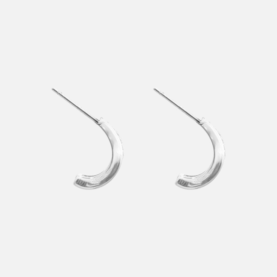 side view of Aurea Double Hoop Earrings,  crafted from a 925 sterling silver base with white gold plating and a pave hoop